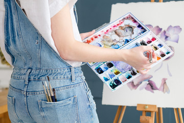 Obraz premium artist instruments and tools for creative leisure. watercolors brushes and color swatches. painting hobby