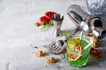 Mojito cocktail making. Mint, lime, glass, ice, ingredients and shaker