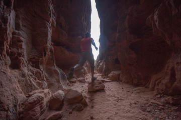 Hiker on a trail in volcanic Snow canyon State Park in Utah, USA