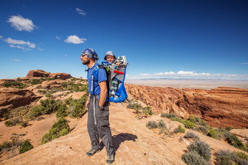 Fototapeta premium A family with baby son visits Arches National Park in Utah, USA