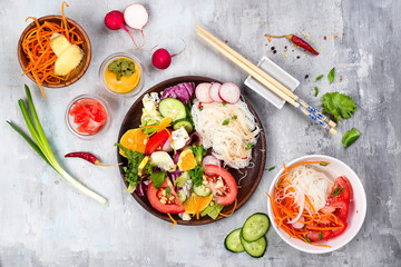 Spicy glass noodles with vegetables - carrots, cucumber, peppers, garlic.