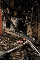 Burnt down building with wood beams destroyed