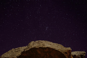 Stone, rock against the night, starry sky.