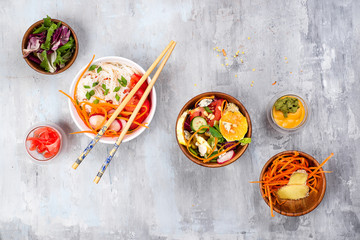 Asian spicy salad of glass noodles or funchoza with carrots and vegetables salad on stone background