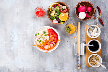 Asian spicy salad of glass noodles or funchoza with carrots and vegetables salad on stone background