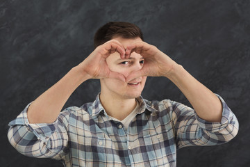 Happy man making heart with her fingers