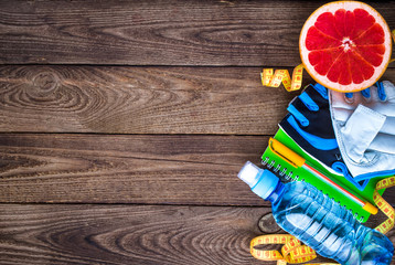 Fitness concept with dumbbells and fresh fruits