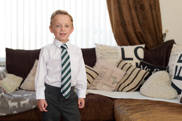 Young boy dressed in new uniform and ready for school