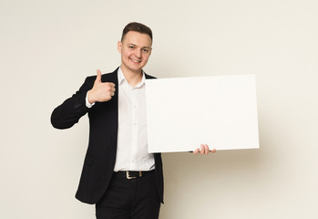 Young businessman with blank white paper