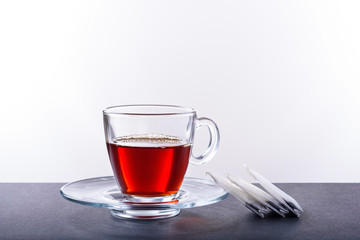 Cup and saucer with herbal tea on a white background