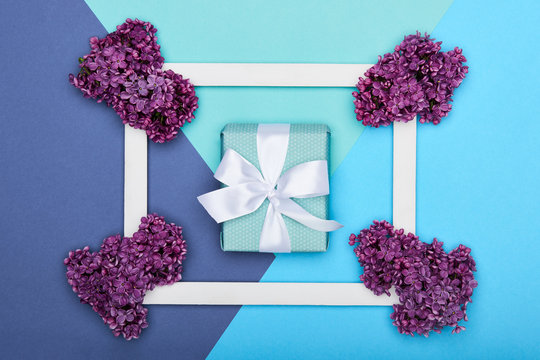 Happy Father's day or Birthday Pastel Candy Blue Colour Background. Floral flat lay greeting card with picture frame mock up and wrapped gift box.