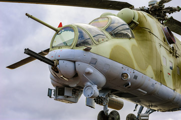 Low angle view to gun, cockpits and part of the fuselage of a Mil Mi-24 (NATO reporting name: Hind) military attack helicopter.