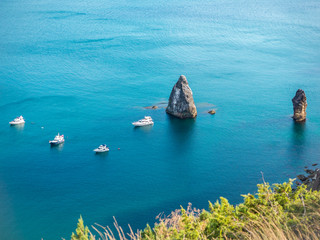 the rocky islands. high rocky cliff and boats at sea. Aerial view