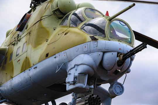 Low angle view to gun, cockpits and part of the fuselage of a Mil Mi-24 (NATO reporting name: Hind) military attack helicopter.