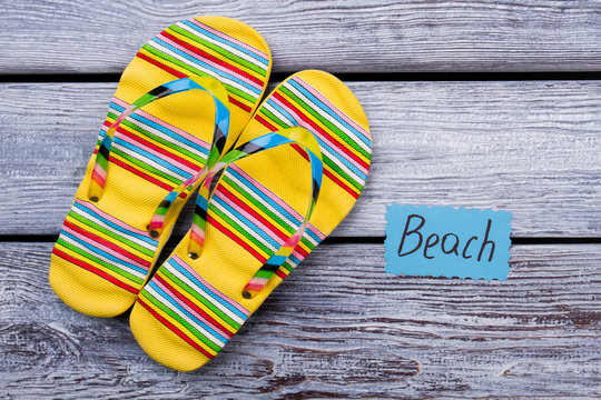 Beach footwear concept, yellow sandals. Flat lay, pair of flip flops
