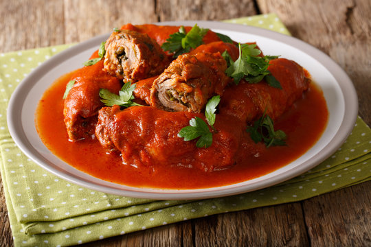 Italian bracilole: tender beef stuffed with parsley and parmesan cheese in tomato sauce close-up. horizontal