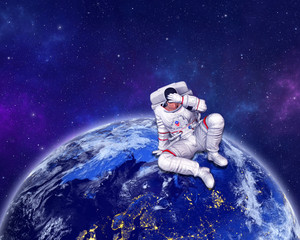 Astronaut sitting on Planet Earth surface, holding hand on head. Elements of this image furnished by NASA. 3D rendering.