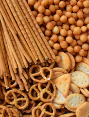 Salty snacks. Crackers, pretzel, salted straws, nuts. Junk food for beer or cola. Photographed with natural light