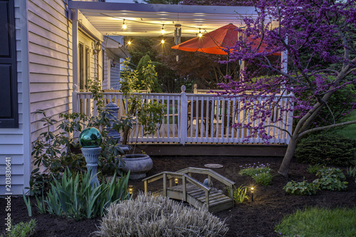 White Two Story Colonial Home With Finished Deck Bistro Lights Red