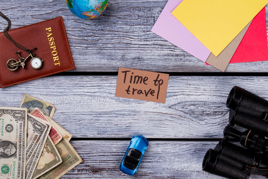 Travel And Vacation Items On Table. Overhead top view, flat lay, accessories and essential travel items on grey wooden table.
