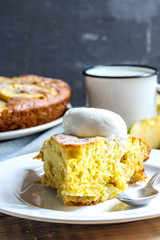 Apple cake on the plate with ice cream and milk on a wooden table. Selective focus