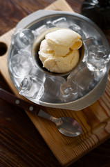 Homemade caramel sundae with white chocolate and parmesan in a plate with ice. Top view