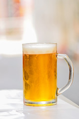 Cold weiss beer in glass with bokeh background