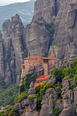 Fototapeta na wymiar Monastery Meteora Greece. Stunning spring panoramic landscape. View at mountains and green forest. Unesco heritage list object.