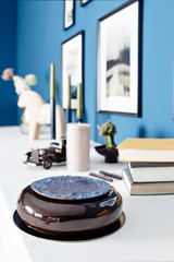 Luxury round chocolate dessert, with a blue disk on Black glaze. Mousse birthday cake with decor. on a wooden table