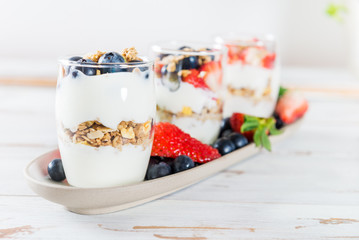 Little Jars with layered dessert from natural yogurt, granola an
