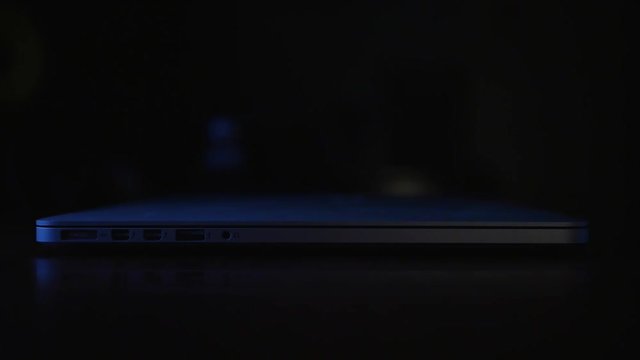 Shutting down the laptop. Men hands close notebook
