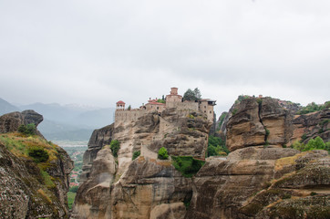 Fototapeta na wymiar Monastery Meteora Greece. Stunning spring panoramic landscape. View at mountains and green forest. Unesco heritage list object.