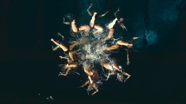 Synchronized swimmers performing underwater