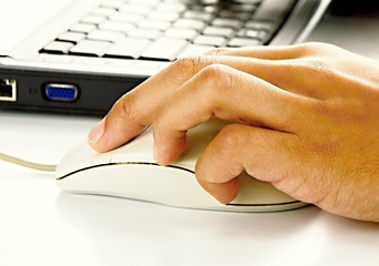 hand with mouse on PC keyboard on table