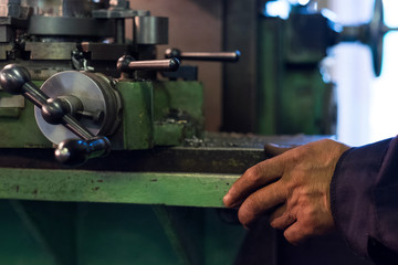 Worker manipulate old machine on factory