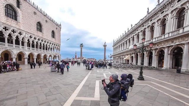 Timelapse of Campanile di San Marco and Palazzo Ducale Doge's Palace in Venice, Italy. Columns of San Marco and San Todaro. Blue cloudy sky at 4K