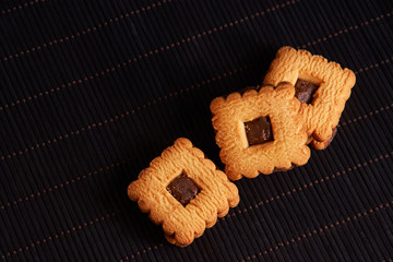 Chocolate sand chip cookies stacked up on a plate, ready to be served. with copyspace