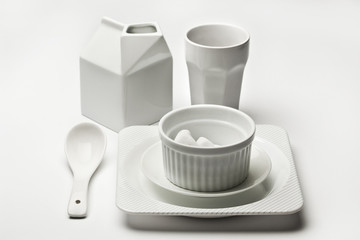 White ceramic dishware with marshmallows on white background