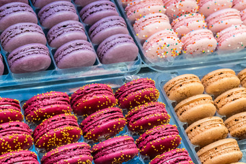 French desert, fresh colorful macarons in the bakery, red, violet, pink colors