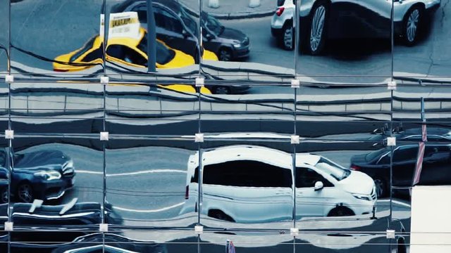Abstract moving city traffic reflections in building mirror windows. Slow motion