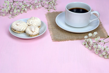 Coffee and dessert, white flowers on a pink background. Copy space.