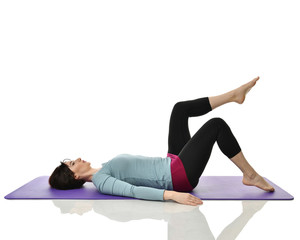 Obraz premium Mother woman exercising doing postnatal workout. Female fitness instructor stretching hands and legs in gym and work out exercises