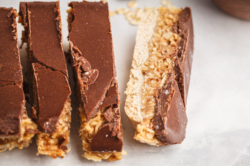 Coconut-oat raw vegan cake. Top view, light background, copy space. Healthy vegan food concept.