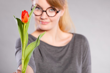 Blonde woman with single tulip.