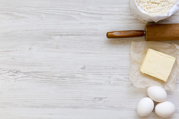 Ingredients for dough preparation on white wooden background, from above. Copy space. Flat lay. Top view.