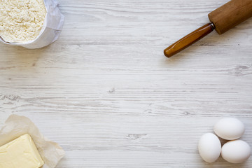 Ingredients for dough preparation on white wooden background, from above. Copy space. Flat lay. Top view.