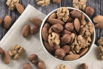 Mixed nuts - hazelnuts, walnuts, almonds in white bowl