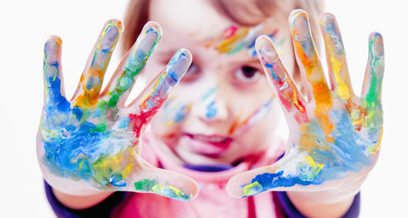 Cute little girl with hands painted in bright colors. (art, childhood, color, creativity concept)