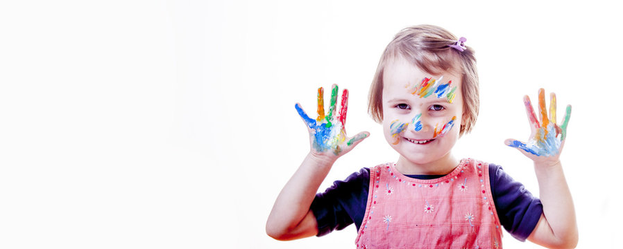 Cute little girl showing her hands painted in bright colors. (art, childhood, color, creativity concept)