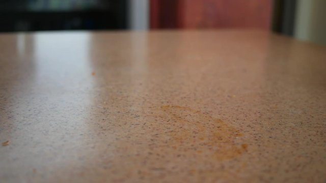 Woman picks up leftovers on table wrapped in aluminum foil